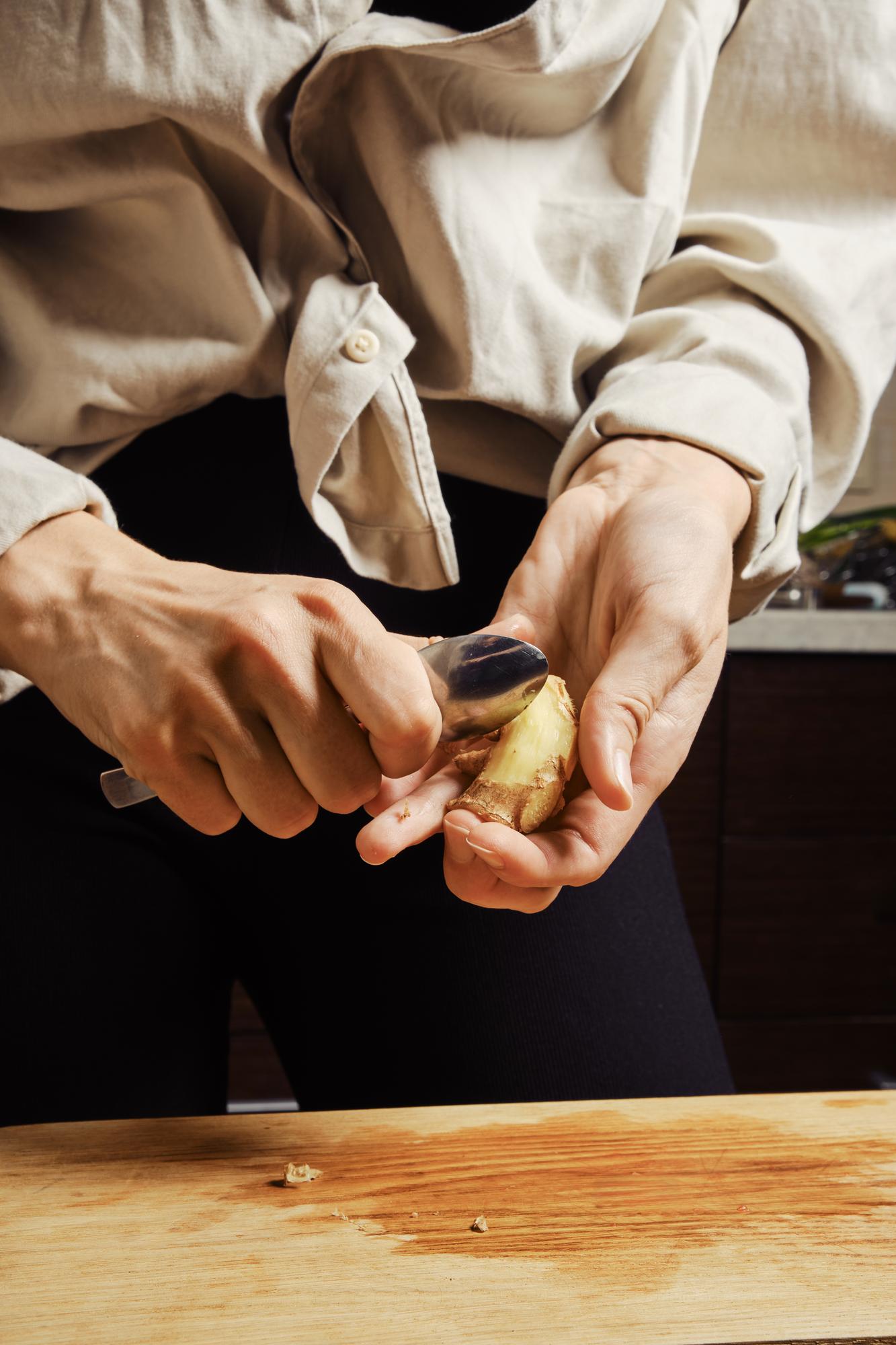 Chef preparing plated dish on wooden table
